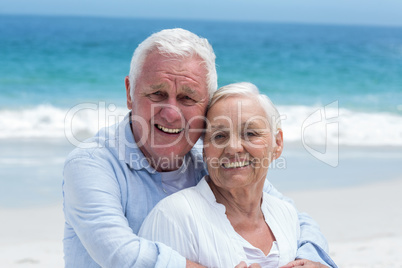 Senior couple embracing with arms around