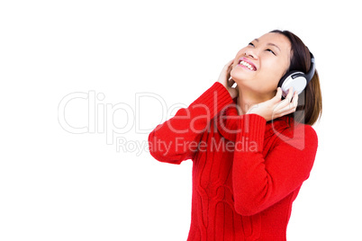 Young woman listening to music on headphone