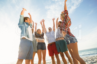 Friends raising their arms