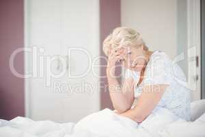 Portrait of senior woman suffering from headache