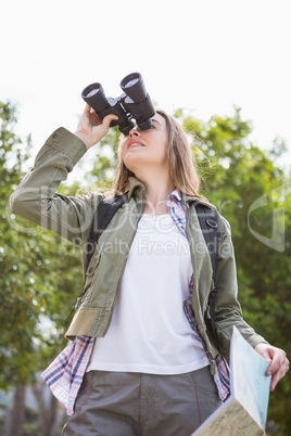 Woman using map and binoculars