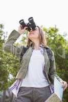 Woman using map and binoculars