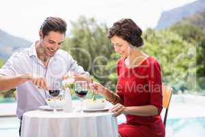 Smiling couple having food