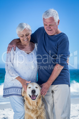Cute mature couple petting their dog