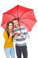 Happy young couple holding umbrella