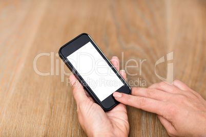 Cropped hand of woman using smart phone