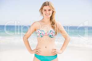 Portrait of happy woman in bikini standing on the beach