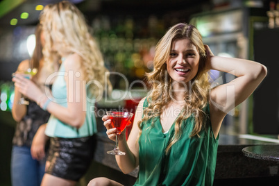 Blonde woman drinking cocktail