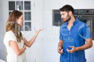Young couple arguing in kitchen