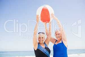 Senior woman holding beach ball