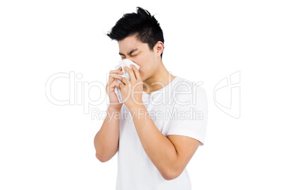 Young man wiping his nose