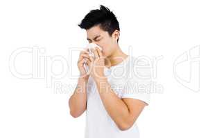 Young man wiping his nose