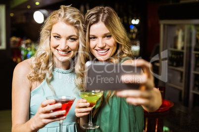 Smiling friends taking a selfie