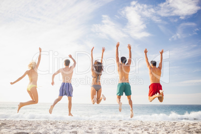 Happy friends jumping together