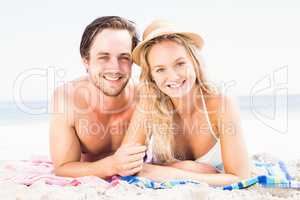 Portrait of young couple lying on the beach
