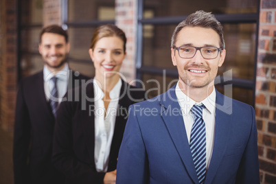 Happy business people standing in row