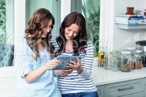 Friends watching video on digital tablet