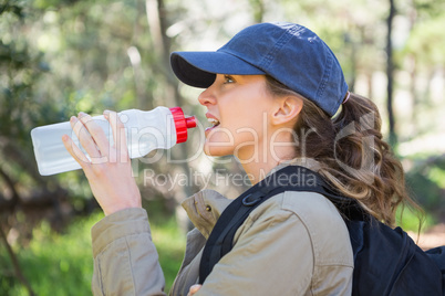 Woman drinking water while doing a break