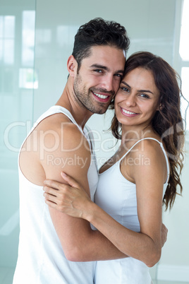 Young couple smiling while embracing at home
