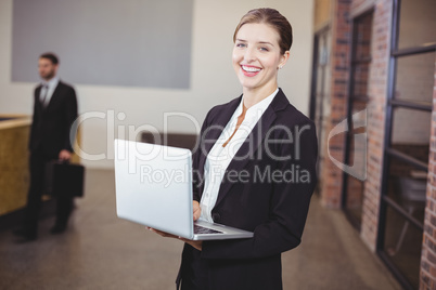 Beautiful businesswoman using laptop in office