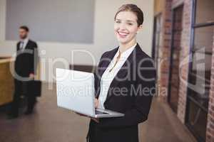 Beautiful businesswoman using laptop in office