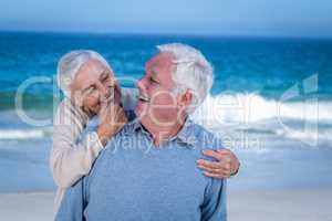 Senior couple embracing at the beach