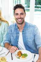 Portrait of happy man having food