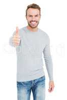 Young man smiling and giving a thumbs up