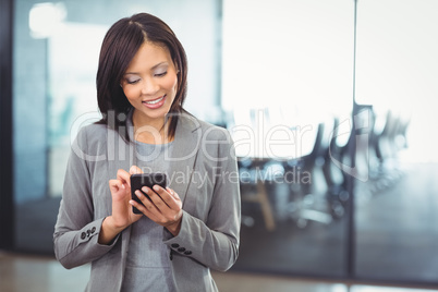 Attractive businesswoman using mobile phone