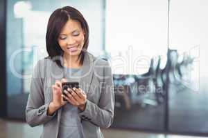 Attractive businesswoman using mobile phone