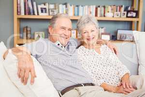 Portrait of happy senior couple sitting on sofa