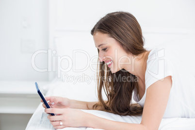 Smiling woman using tablet PC at home