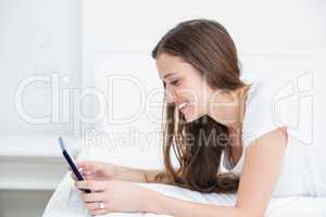 Smiling woman using tablet PC at home