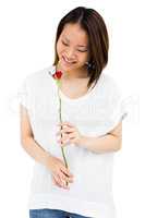 Happy young woman holding rose