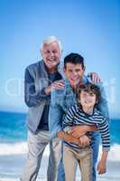 Male family members posing at the beach