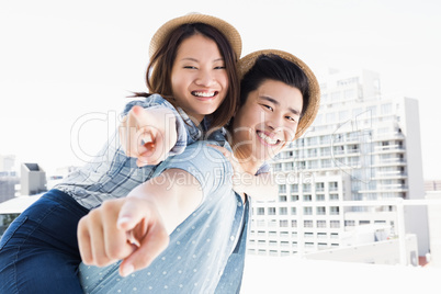 Young man giving a piggyback ride to woman