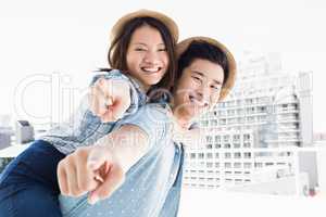 Young man giving a piggyback ride to woman