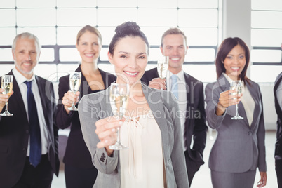 Portrait of business team holding champagne flute