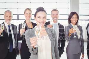 Portrait of business team holding champagne flute