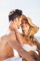 Young couple sitting on sand