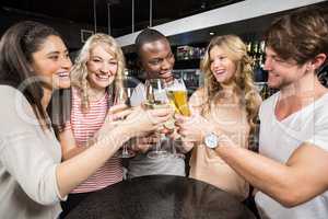 Group of friends toasting with beer and wine