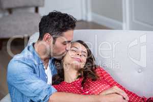 Man kissing woman with eyes closed