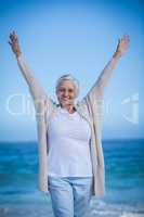 Happy mature woman outstretching her arms