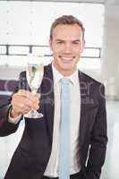 Portrait of businessman holding champagne flute