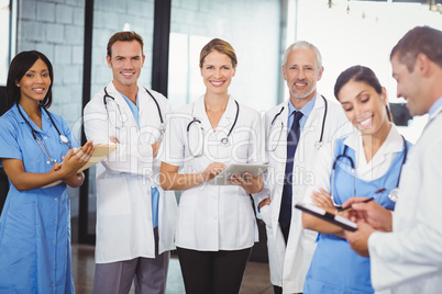 Portrait of medical team standing with file and clipboard