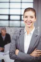 Businesswoman smiling while business people in background