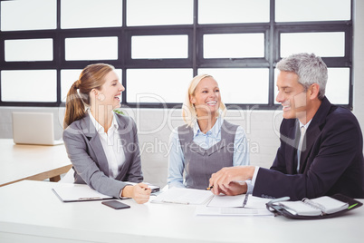 Business people smiling while discussing with client