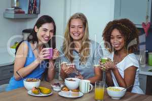 Portrait of multi ethnic friends having coffee at table