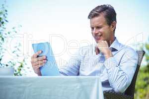 Businessman using tablet with coffee