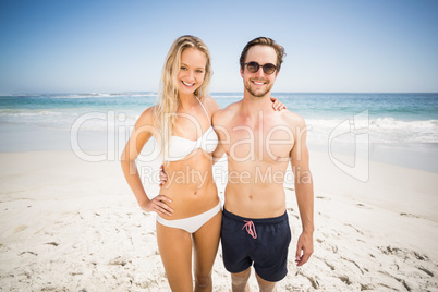 Portrait of young couple standing on the beach